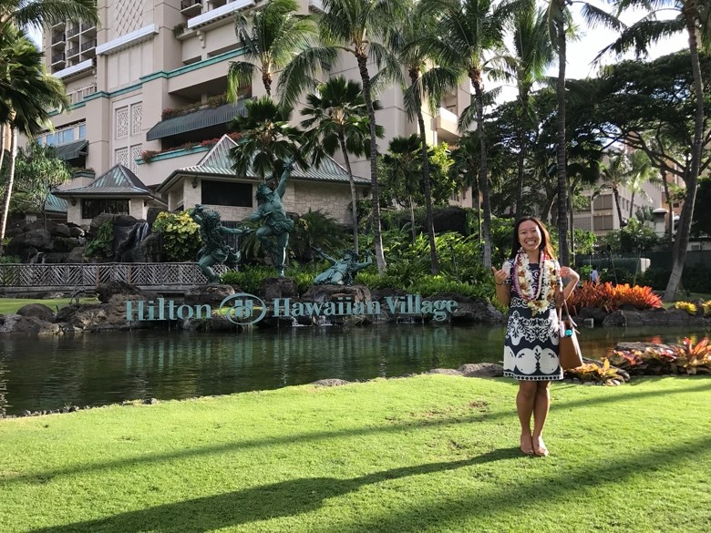 A person standing in front of a body of water

Description automatically generated