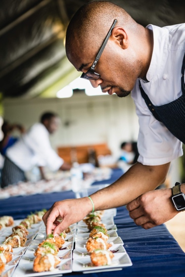 A person in a white shirt and apron

Description automatically generated