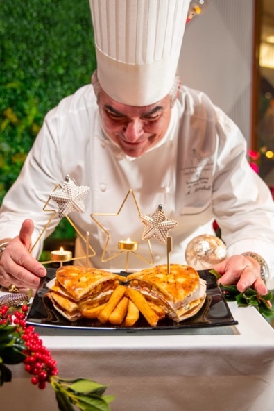 A chef in a white uniform

Description automatically generated