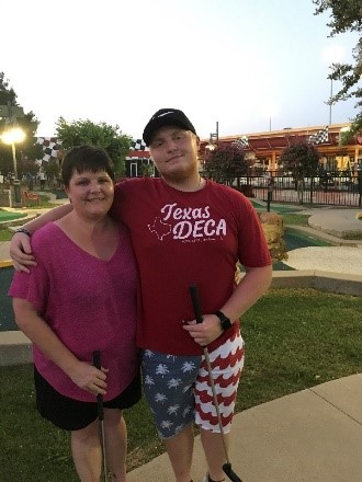 A person and person posing for a picture

Description automatically generated with medium confidence